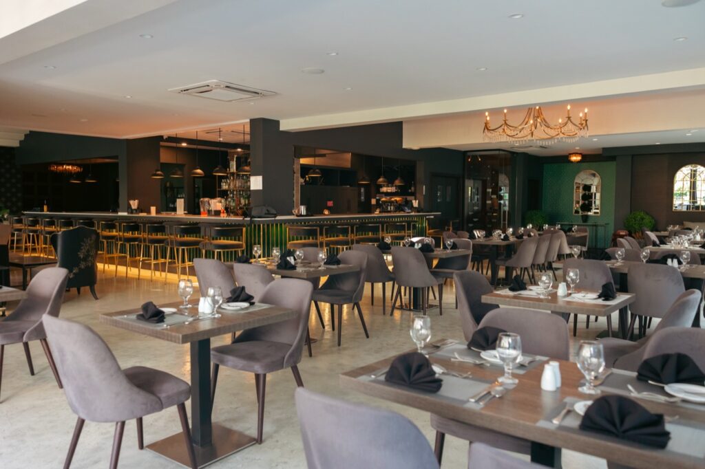 The Ivy dining room, tables set beneath the chandeliers