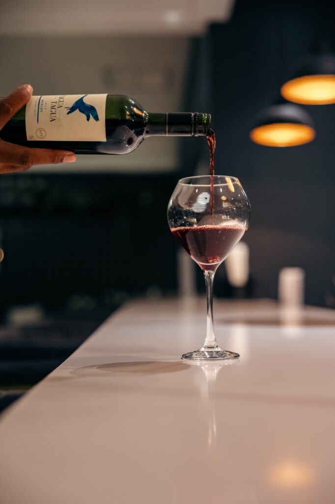Red wine poured at the bar for Wine Down Wednesdays at The Ivy Steakhouse