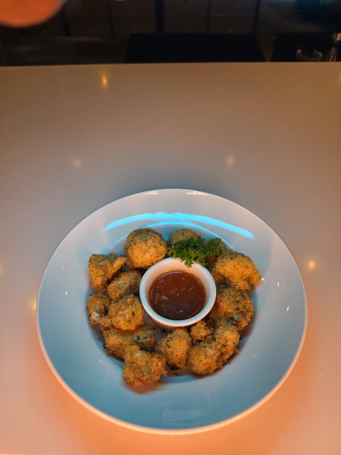 Crispy cauliflower bites in a bowl with a dipping sauce